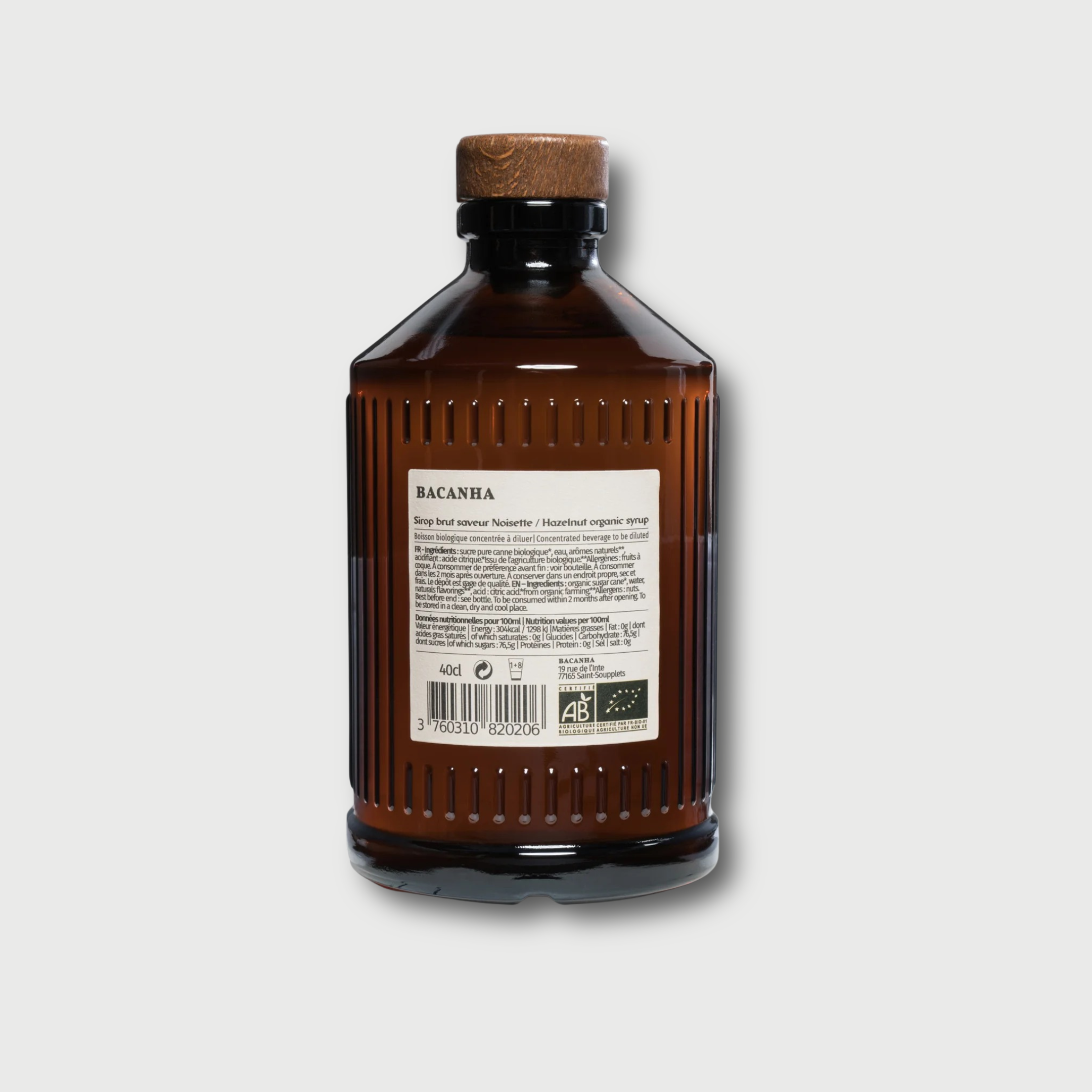 Brown Bacanha Hazelnut bottle with cork stopper on a light gray background