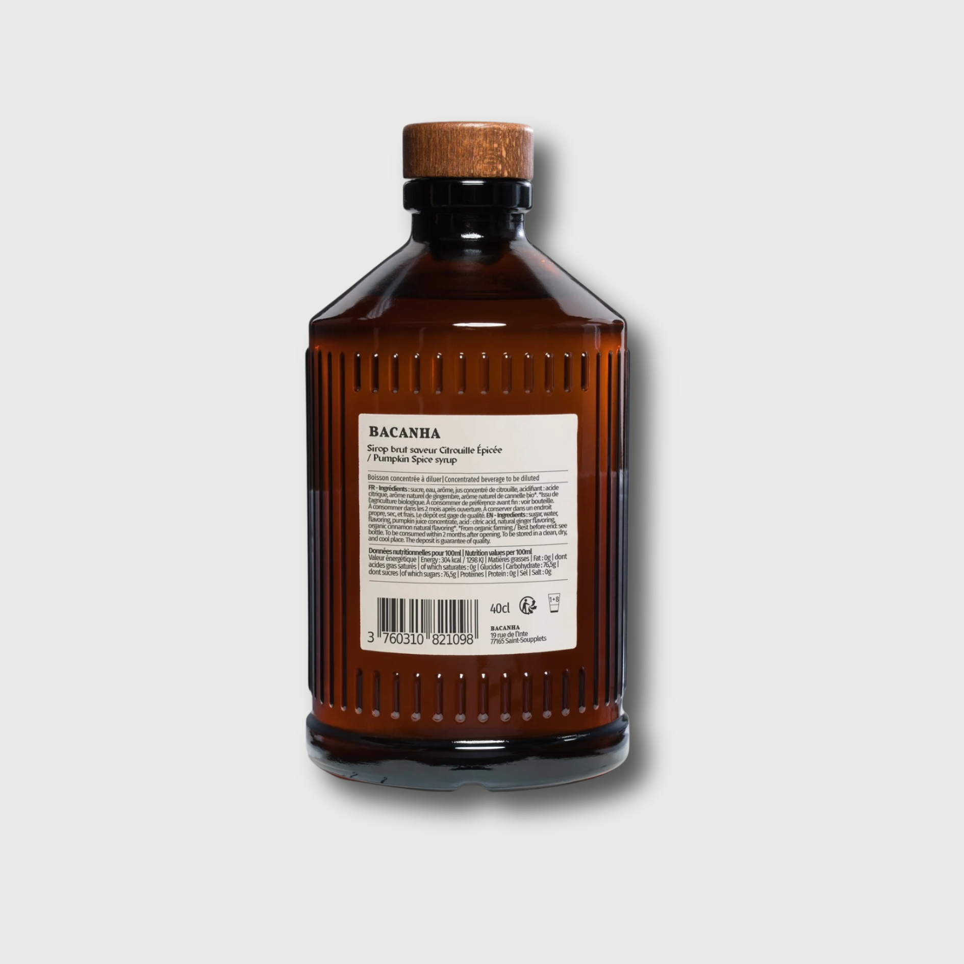 Brown glass Brut Bacanha Vanilla bottle with wooden cap on a light gray background