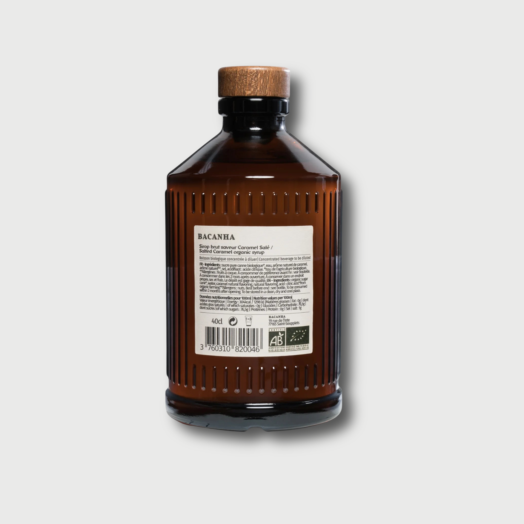 Brown Bacanha Salted Caramel bottle with a cork lid on a light gray background