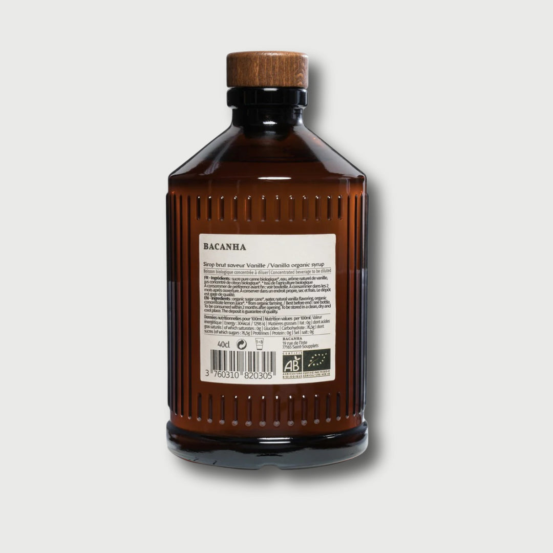 Brown glass Brut Bacanha Vanilla bottle with wooden cap on a light gray background