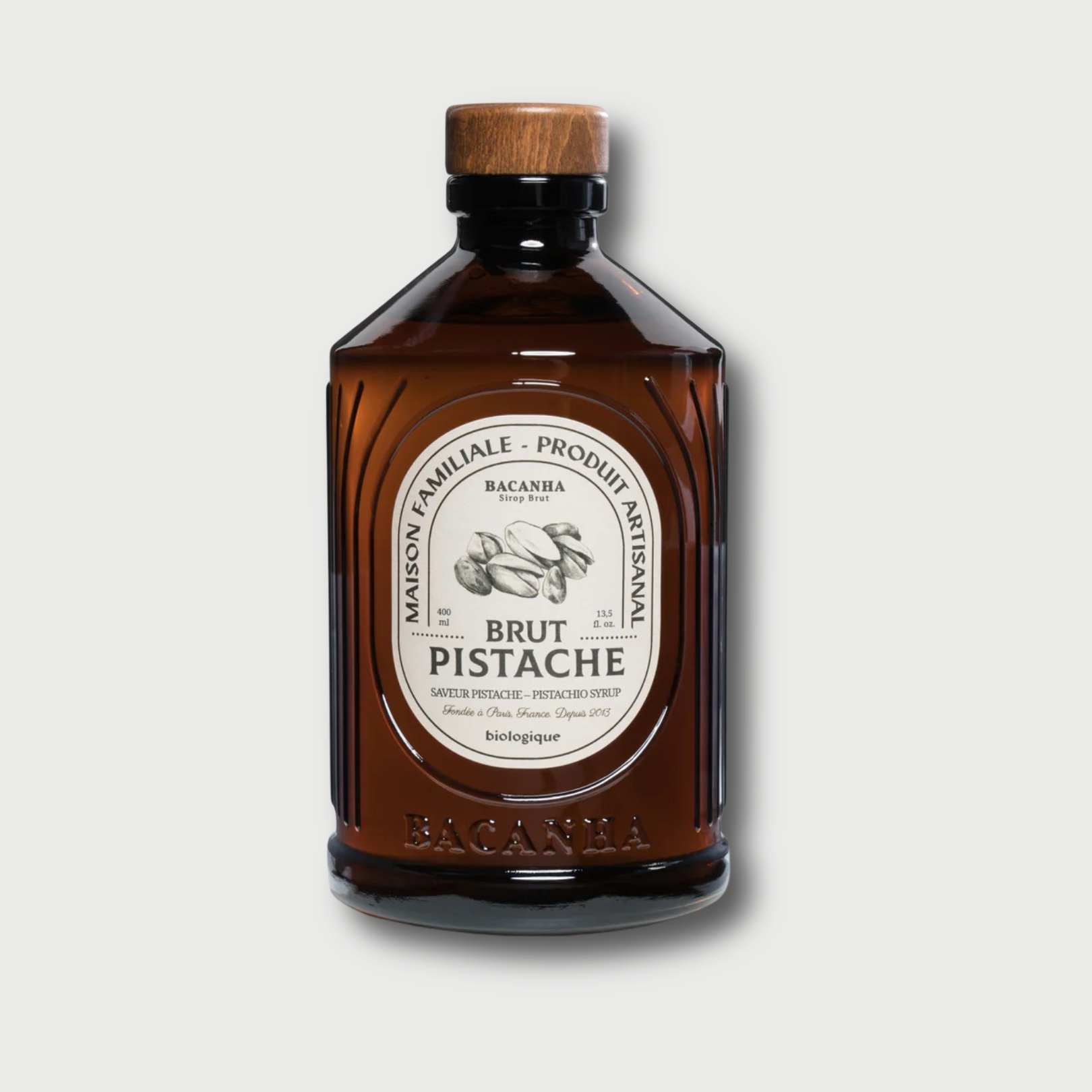 Brown Bacahna Pistache bottle with wooden cap on a white background 