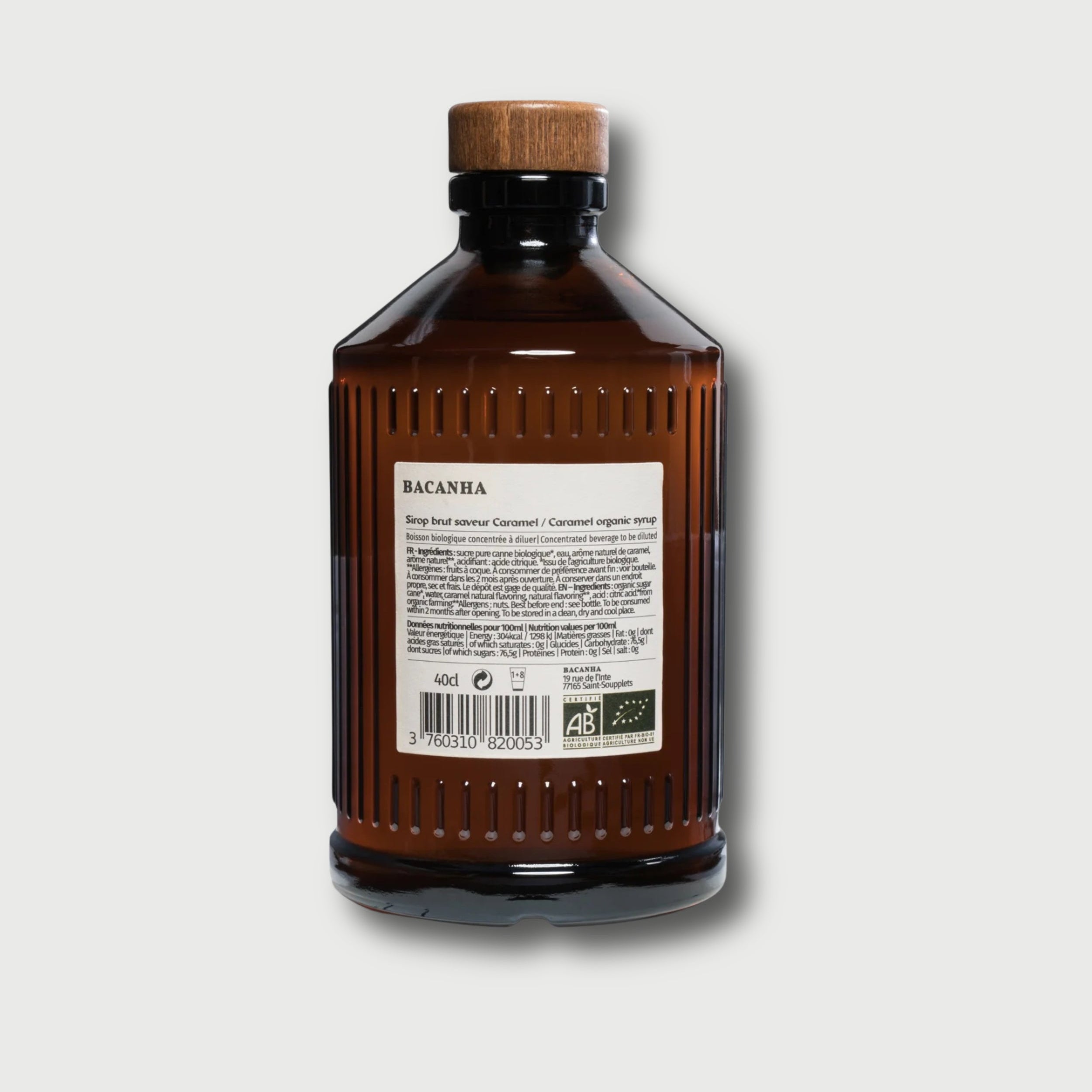 Brown Bacanha Caramel bottle with wooden cap on a light gray background