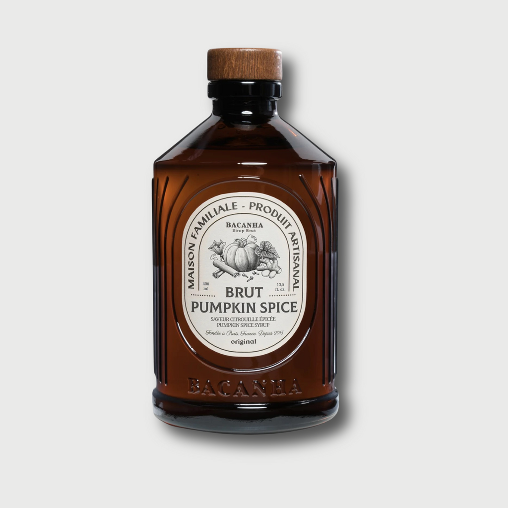 Brown glass Brut Bacanha pumkin spice bottle with wooden cap on a light gray background
